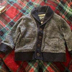 Featuring an Oshkosh baby cardigan, which is blue gray, great for a cold night.